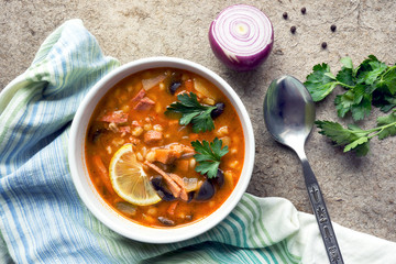 Solyanka - russian traditional meat soup in a bowl. Top view. 