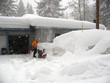 Snowblower/A person pushes a snow blower through very deep snow during a blizzard