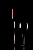 Fototapeta Panele - Red wine glass and bottle silhouette isolated on black background