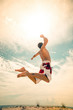 © YURII Seleznov - male beach volleyball game player jump on hot sand