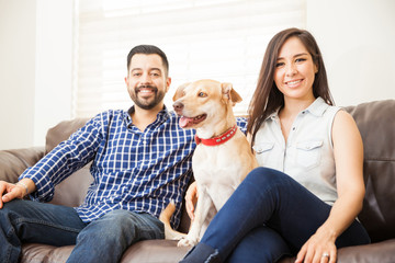 Attractive couple with a dog at home