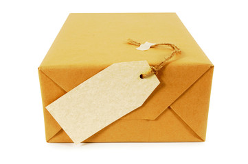 Wall Mural - One single small mail package parcel with label or gift tag wrapped brown paper tied with string isolated on white background photo