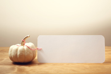 Wall Mural - blank message card with white pumpkin