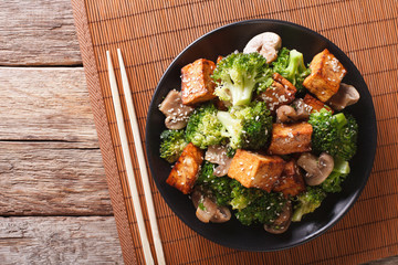 Savory sauteed mixed chinese vegetables with crispy fried tofu. Horizontal top view
