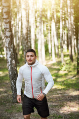 Wall Mural - Serious confident man running in the trees