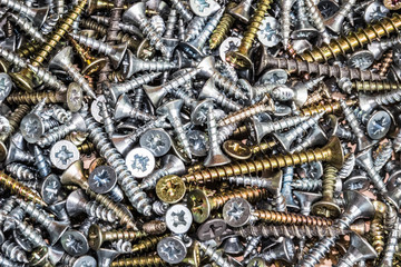 Wood screws cross shaped head on a table close up