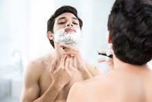 Man Shaving In The Bathroom.