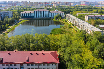 Wall Mural - Tyumen, Russia - August 18, 2016: Aerial view onto Office building on Pond Duck and residential houses