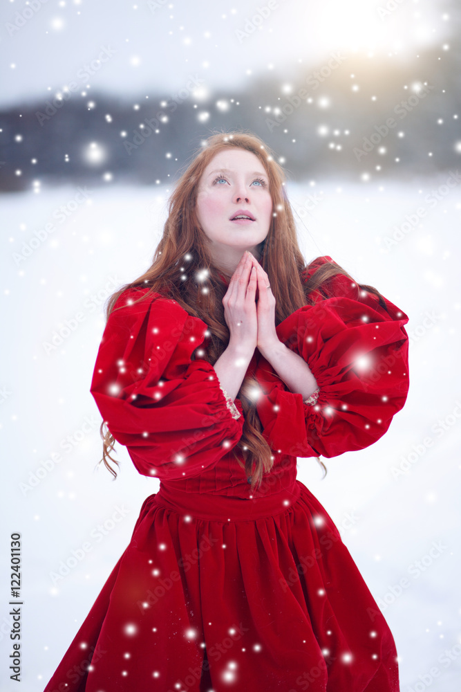 Praying woman in red dress in winter. Fairy tale girl over winter  landscape. Christmas. Stock Photo | Adobe Stock
