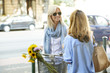 © sepy - Women talking on the street. Shot of two middle age woman talking with each other in urban scene while on coffee break.