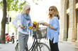 © sepy - Women talking on the street. Shot of two middle age woman talking with each other in urban scene while on coffee break.