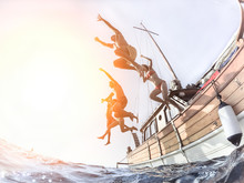 Group Of Multiracial Young People Jumping Off From Sailing Boat Into The Sea 