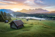 View over Geroldsee with wooden hut and Karwendel mountains at early morning, Bavaria, Germany