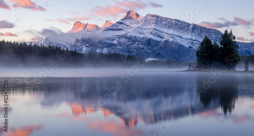 Rundle Mountain reflecting in Two Jack Lake in Banff National Park at sunrise. 