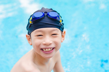 Young asian boy happy at swimming pool