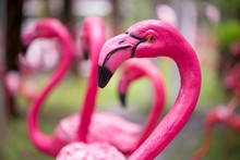 Close-up Detail Of A Pink Flamingo Sculpture Decorating A Lawn, With A Blurred Out Background. Home And Garden Decoration Concept.