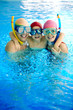 © pressmaster - Happy family in water wearing scuba mask looking at camera