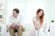 © pressmaster - Young couple with relationship difficulties sitting on sofa at home