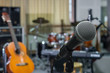 © THANANIT - Microphone over the Abstract blurred photo of music band instrum