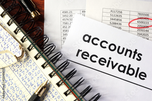 Fotografía Open book with figures and paper with words accounts receivable.