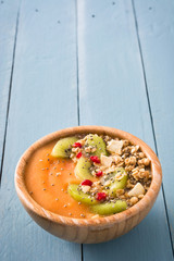 Wall Mural - Smoothie with fruit,cereals and chia on blue wooden table

