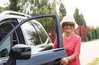© alexsokolov - Attractive well-dressed senior lady in sunglasses and hat came by car