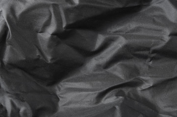 a full page of shiny black fabric background texture