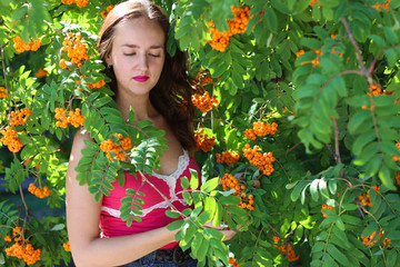 Portrait of a young woman in the branches of Rowan