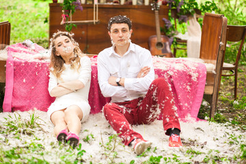 Man and woman play serious sitting on the ground covered with wh