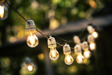 Fototapete - outdoor string lights hanging on a line in backyard