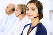 © rogerphoto - Call center. Focus on beautiful woman in headset