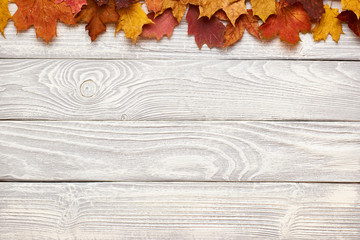 Wall Mural - Wooden background with autumn leaves