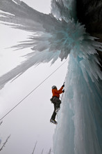 Young Man Ice-climbing In Banff National Park Near Banff, Alberta, Canada.