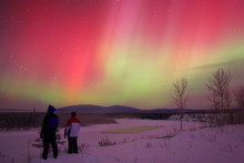 People Watching Aurora Borealis Or Northern Lights, Yukon.