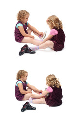 Couple of young little girls sitting over isolated white background