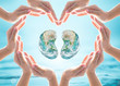 World Kidney Day design logo concept idea: Love heart shape symbolic sign of women human hands on blur blue turquoise clean aqua water background: Element of this image furnished by NASA