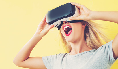 Wall Mural - Young woman using a virtual reality headset