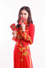 Beautiful Vietnamese woman with red ao dai holding lucky red packet for celebrate lunar new year on white background