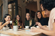 canvas print picture - Smiling women having coffee and chatting