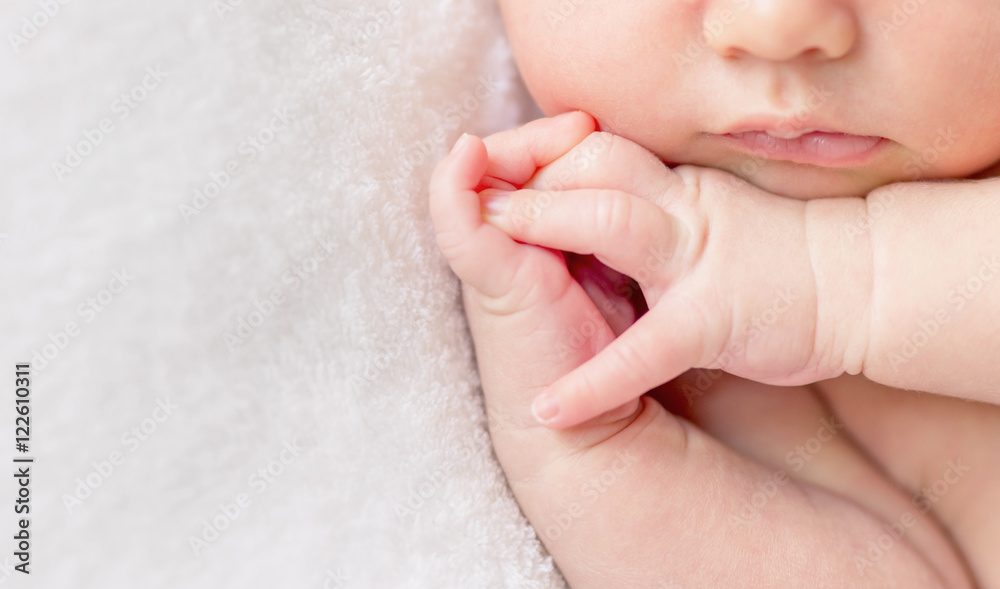 crossed fingers of a newborn baby asleep, closeup - obrazy, fototapety, plakaty 
