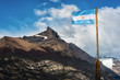 Argentine flag flying in front of the mountain Cerro Moreno in Los Glaciares National Park, Argentina