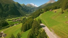 Flying towards alpine village Heiligenblut on sunny summer day, popular tourist destination in Austria