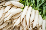 Fototapeta Sawanna - Organic local daikon radish vegetables for sale at outdoor asian marketplace