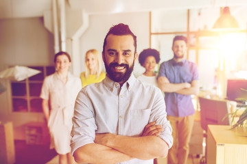 Wall Mural - happy young man over creative team in office