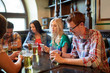 © Syda Productions - friends with smartphones and beer at bar or pub