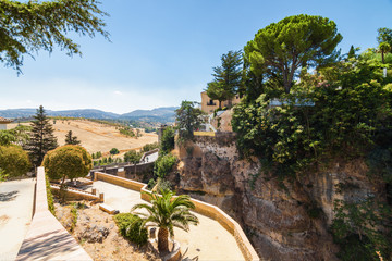 Buildings and viewpoint on the cliffside of El Tajo Gorge in Ronda, Malaga province, Spain.