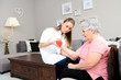 young physiotherapist nurse helping an elderly women physical rehabilitation at home