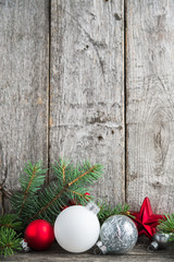 Wall Mural - red, silver and white xmas ornaments on rustic wood background. merry christmas card. winter holiday