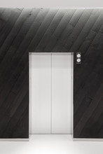 Lift Doors On Wood Panelled Wall