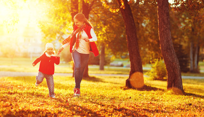 Wall Mural - happy family mother and child little daughter on autumn walk